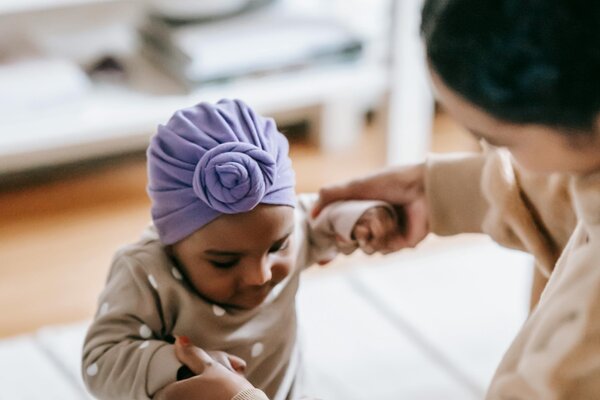 Professional caregiver helping child with mobility and developmental support services